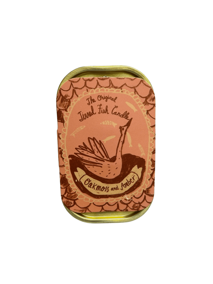 Orange decorative tin of Tinned Fish Candle with 'Oakmoss and Amber' scent on a transparent background | Twentyseven Toronto