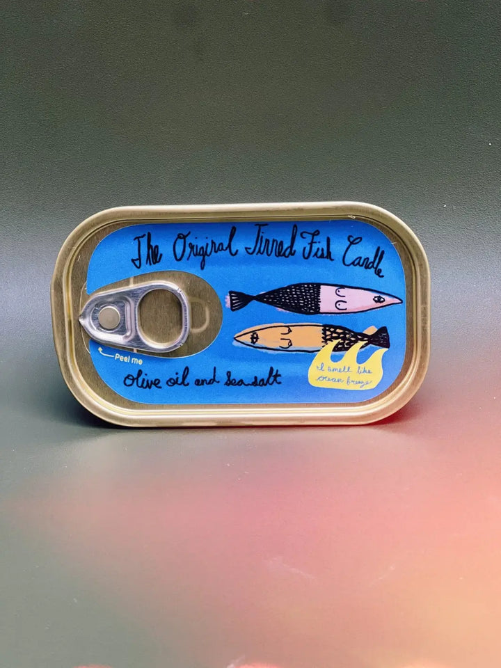 Tinned Fish Candle with artwork on a gray and pink background | Twentyseven Toronto