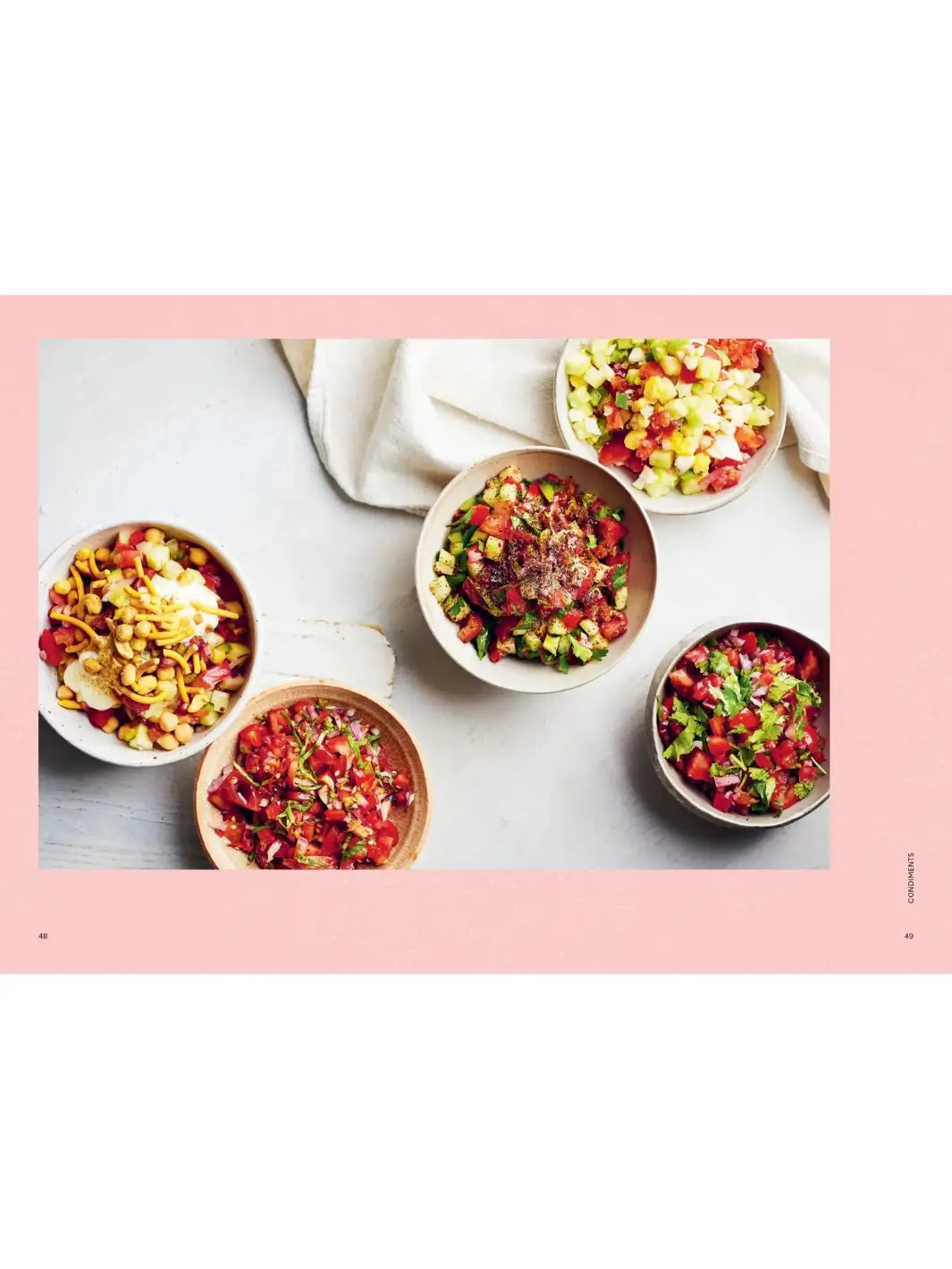 A full-page spread from Tomato: 80 Recipes Celebrating the Extraordinary Tomato by Claire Thomson showcases five different vibrant tomato-based salsas and salads served in individual ceramic bowls | Twentyseven Toronto