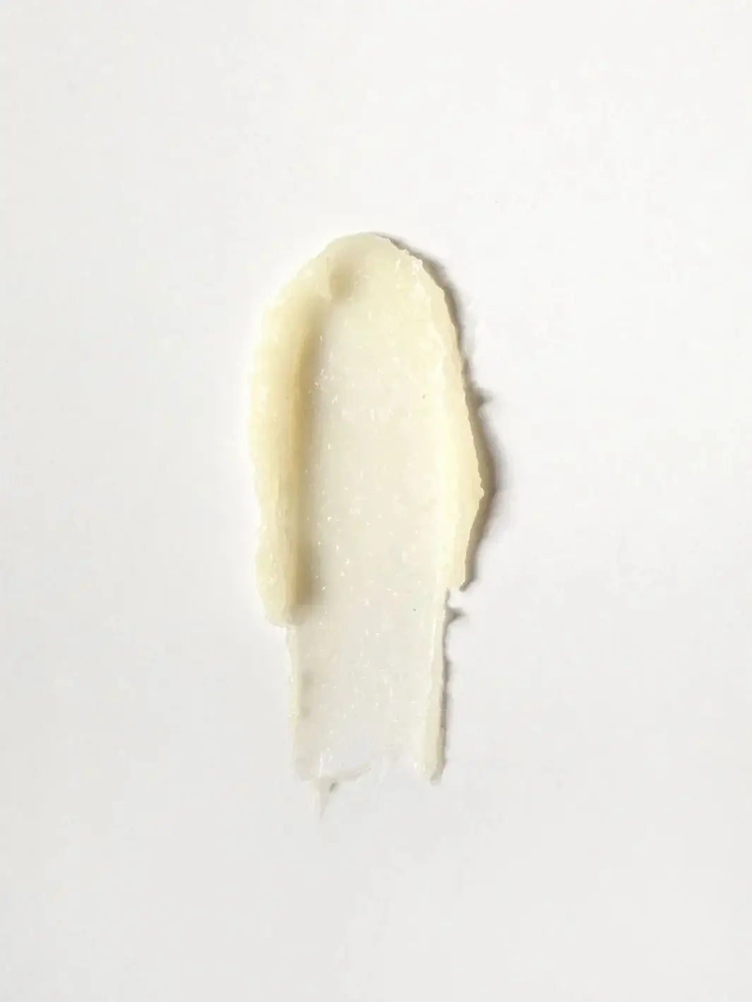 A single, textured swatch of the creamy Dedcool Vanilla Balm Stick spread over a solid white background | Twentyseven Toronto