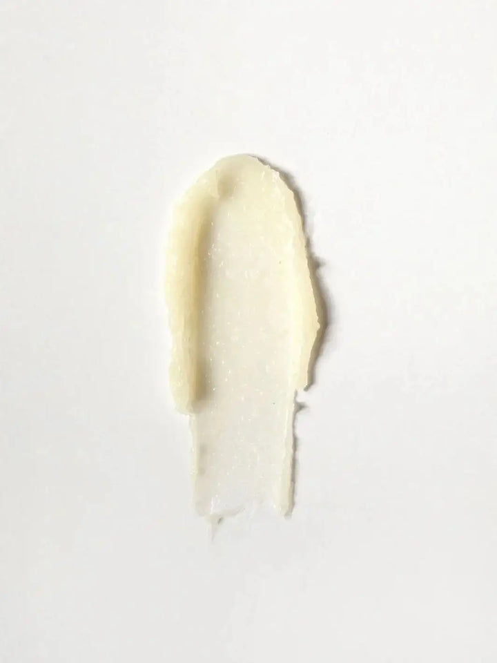 A single, textured swatch of the creamy Dedcool Vanilla Balm Stick spread over a solid white background | Twentyseven Toronto