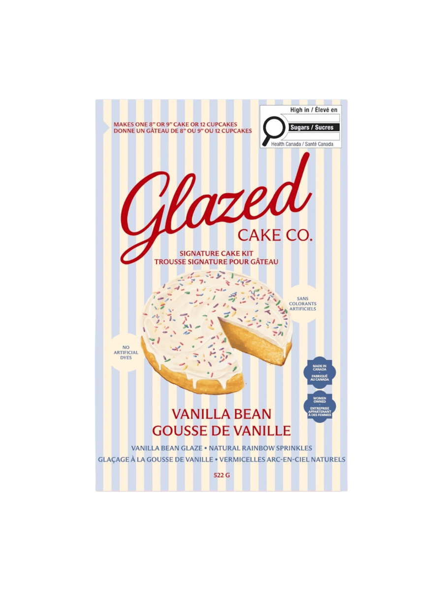 The front of a blue and white striped box showcases the packaging for the Glazed Cake Co Vanilla Bean Signature Cake Kit, displaying an illustration of a frosted cake with sprinkles | Twentyseven Toronto