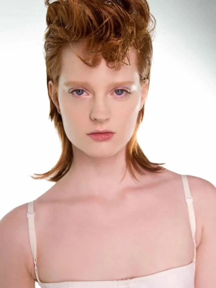 A portrait of a model showcasing a bold, sculpted mullet hairstyle with high-volume texture on top using R+Co VICIOUS Strong Hold Flexible Hairspray | Twentyseven Toronto