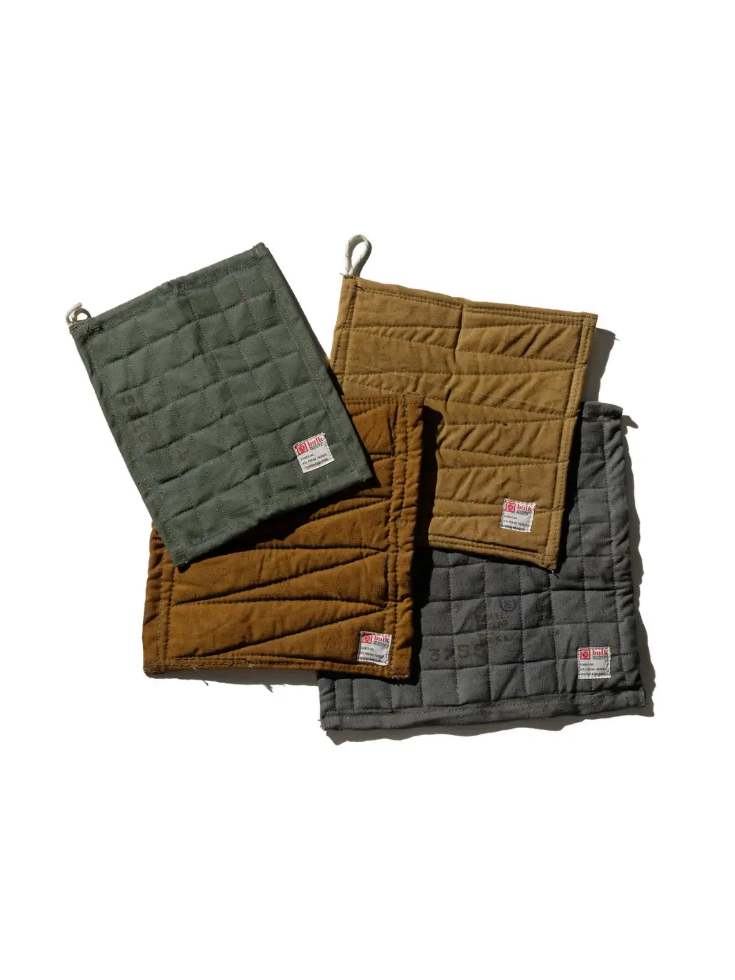 A collection of square and rectangular Vintage Bivouac Trivet from Puebco hot pads showcases both unique diagonal and grid-quilted stitching patterns | Twentyseven Toronto