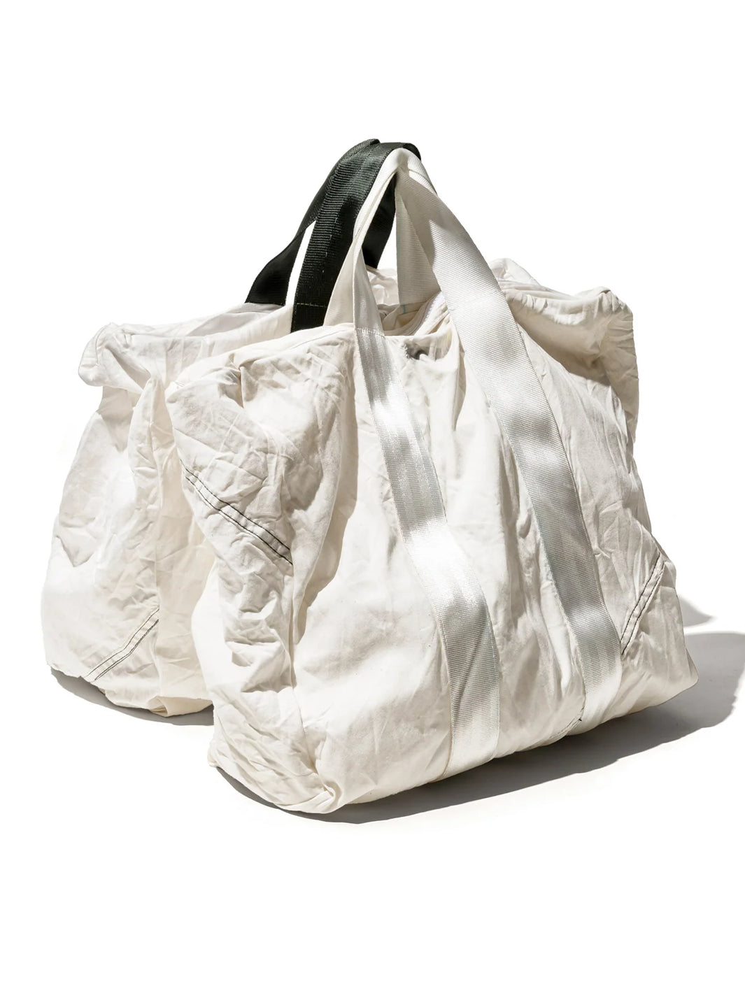 Two Puebco Vintage Parachute Tote Bags in white, featuring crinkled reclaimed fabric and contrasting black and white webbing handles, displayed against a white background | Twentyseven Toronto