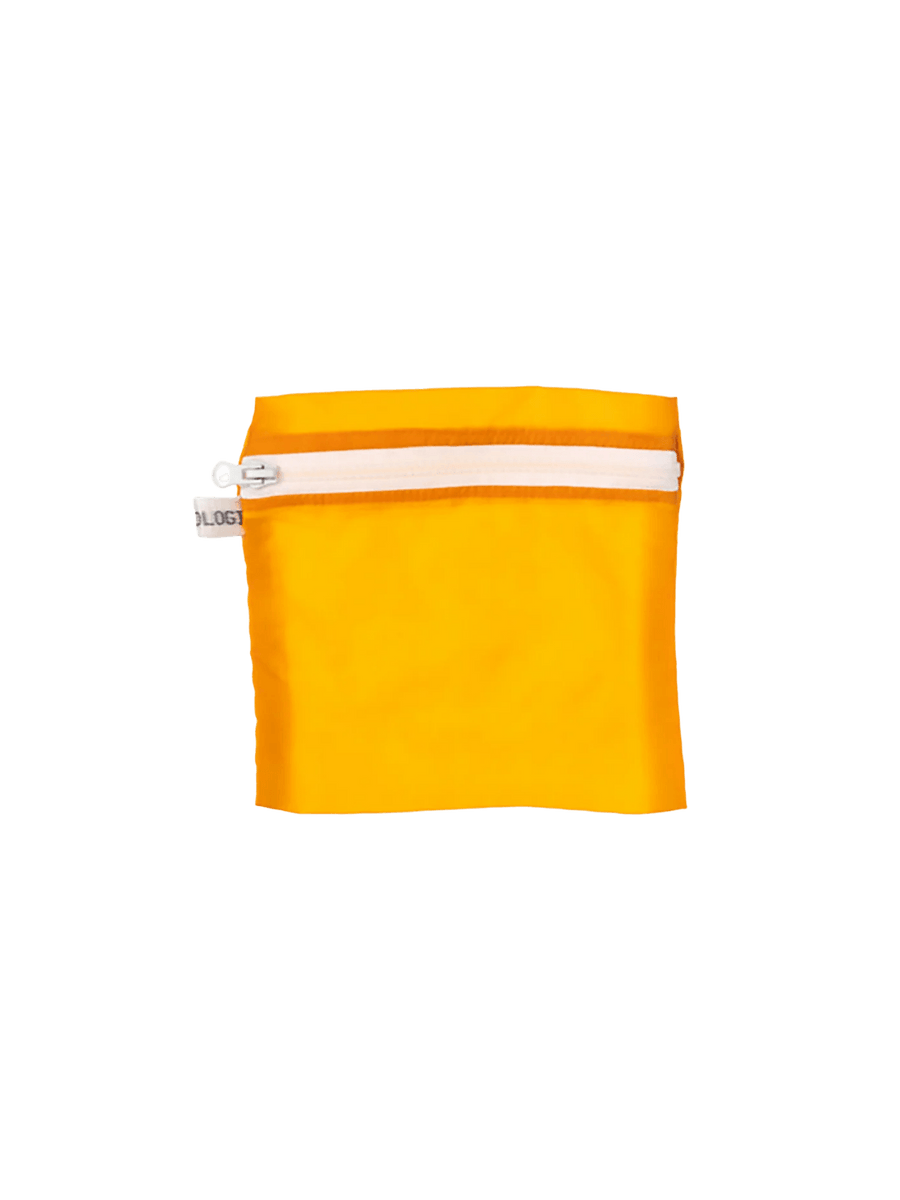 A orange Vintage Parachute Light Pouch Medium from Puebco is shown flat, showcasing its semi-transparent fabric, top zipper, and small stitched branding detail near the bottom | Twentyseven Toronto