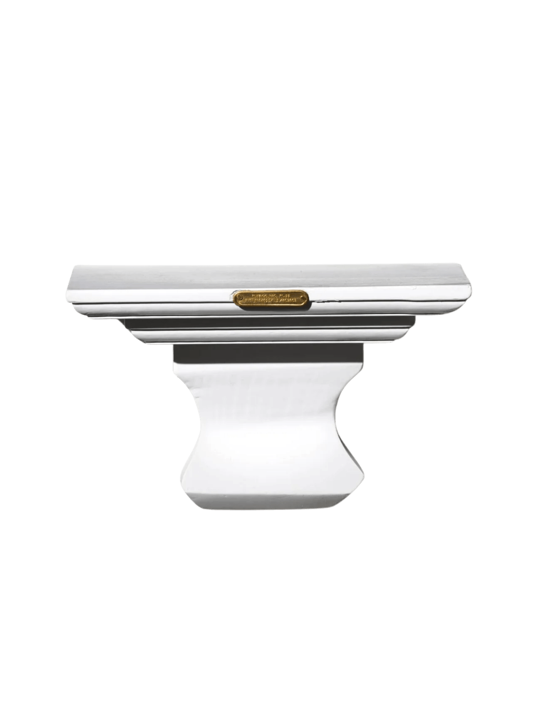 A decorative white Wall Hanging Shelf in Library White highlighting its classical architectural shape and small, rectangular brass plaque on the front | Twentyseven Toronto