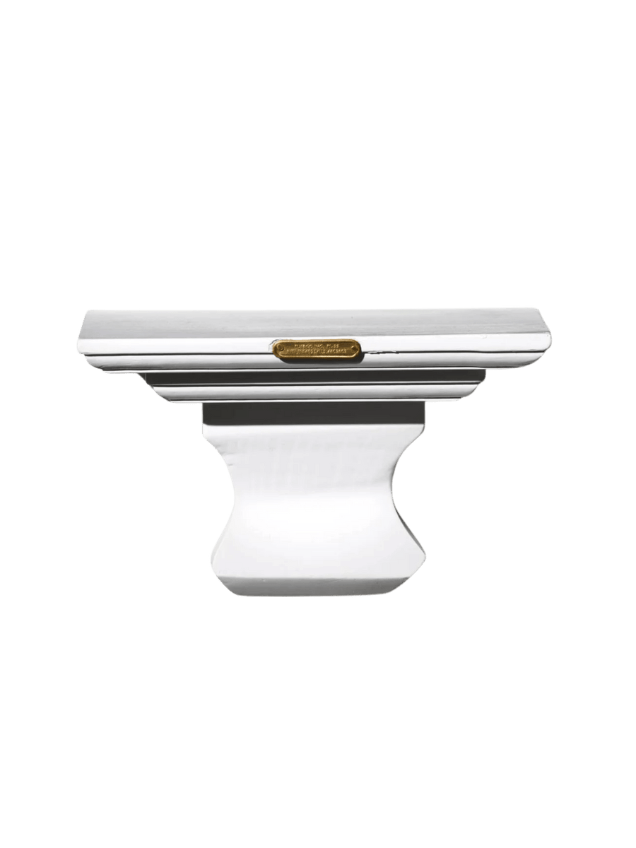 A decorative white Wall Hanging Shelf in Library White highlighting its classical architectural shape and small, rectangular brass plaque on the front | Twentyseven Toronto