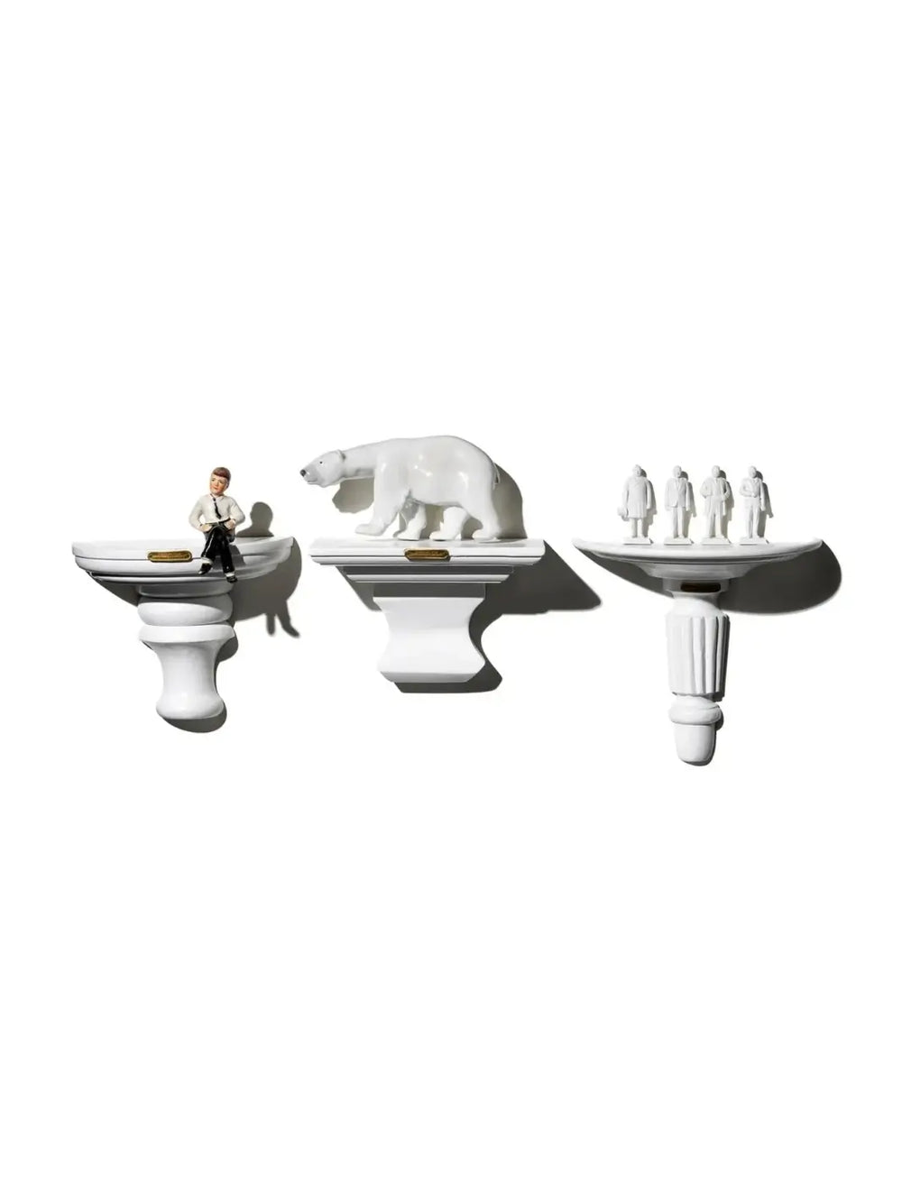Three distinct styles of miniature architectural shelves, including the Wall Hanging Shelf - Library White in the center holding a white polar bear figurine, are mounted side-by-side against a clean white wall to showcase decorative displays | Twentyseven Toronto