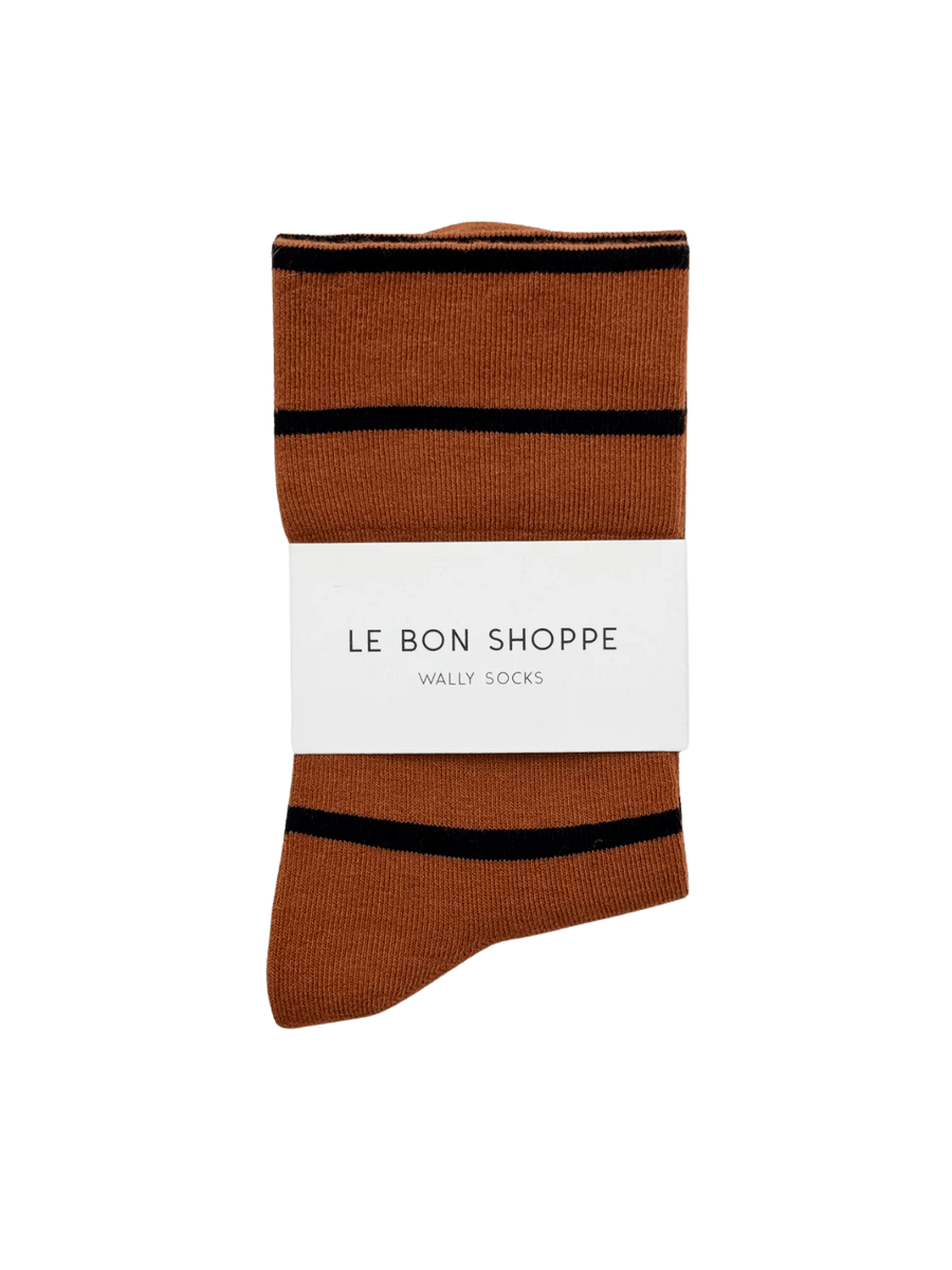 A pair of orange and black striped Wally Socks in Camel from Le Bon Shoppe against a transparent background | Twentyseven Toronto
