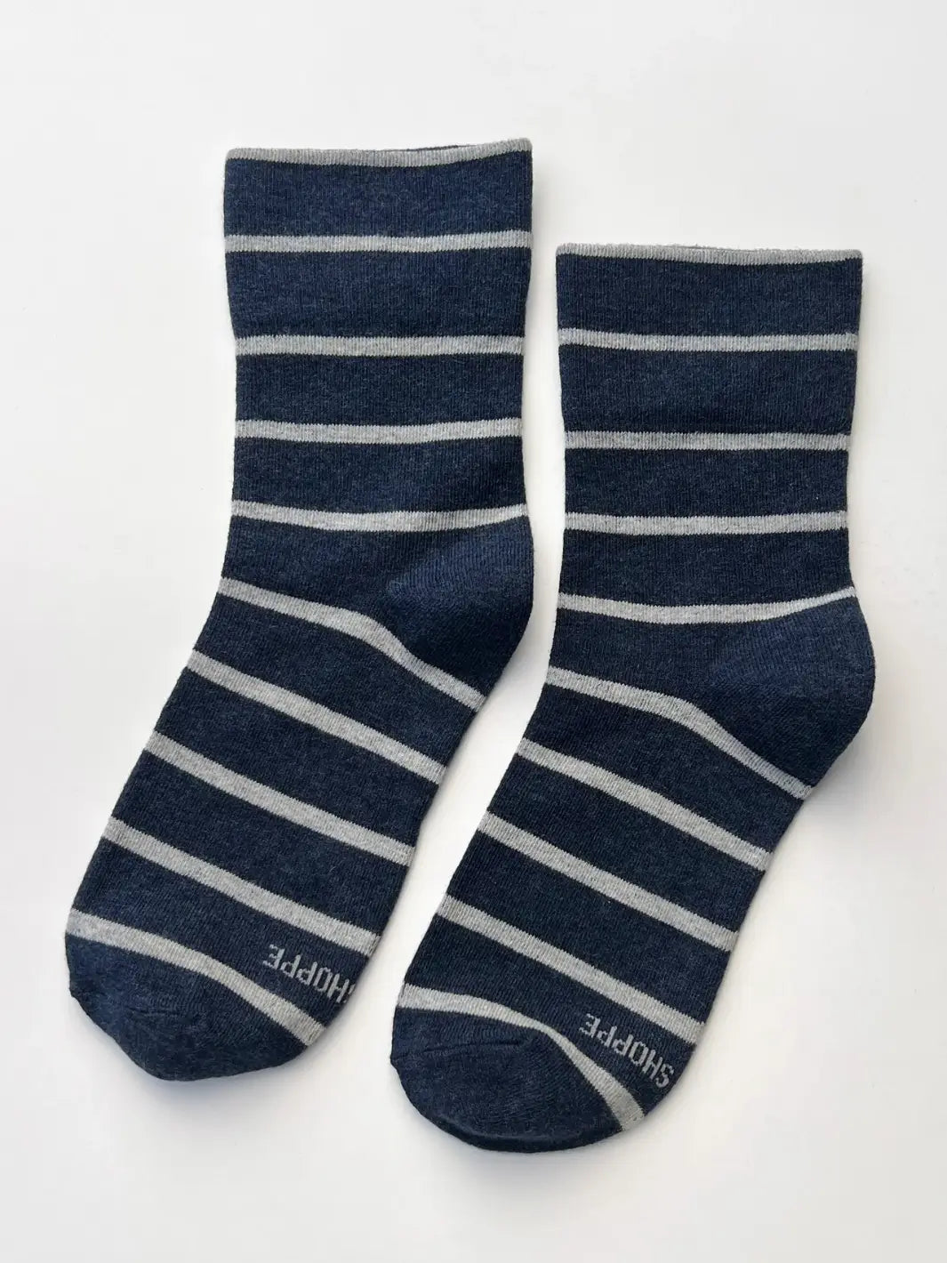 A pair of navy and gray striped Wally Socks in Marine from Le Bon Shoppe is laid out flat against a clean white background | Twentyseven Toronto