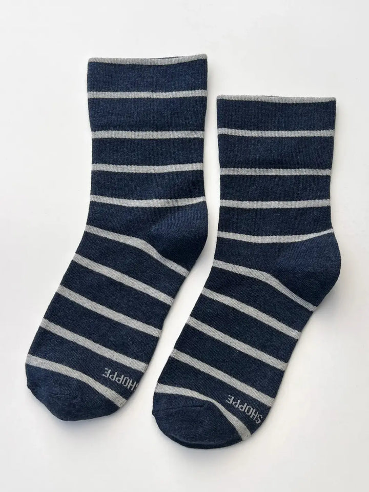 A pair of navy and gray striped Wally Socks in Marine from Le Bon Shoppe is laid out flat against a clean white background | Twentyseven Toronto
