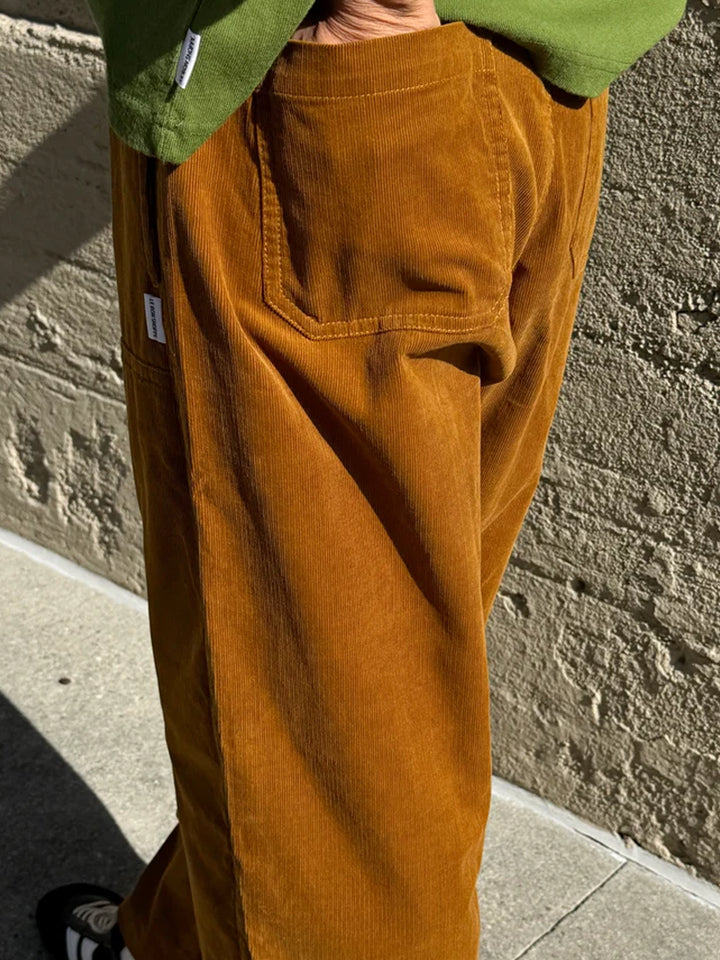 Close-up of Le Bon Shoppe Corduroy Gardener's Pants in Whiskey, showcasing the textured cotton corduroy fabric, functional back pocket and relaxed fit | Twentyseven Toronto