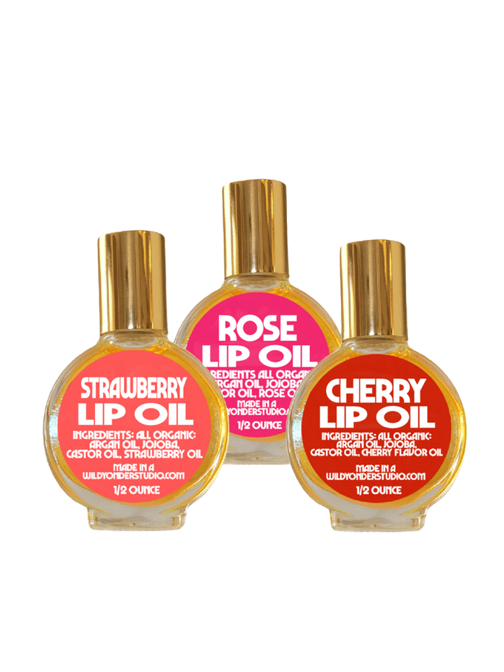 Wild Yonder Studio Lip Oils in Strawberry, Rose, and Cherry, featuring colourful labels and gold caps | Twentyseven Toronto