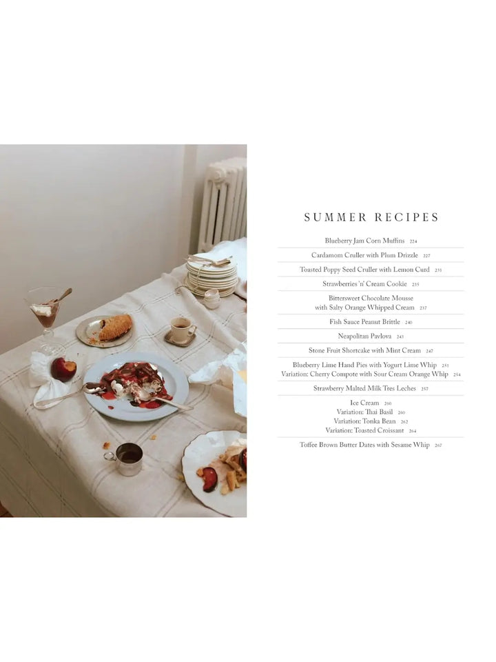 Page from Will This Make You Happy: Stories & Recipes from a Year of Baking by Tanya Bush featuring a "Summer Recipes" table of contents beside a cozy photograph of a table spread with various plated desserts, coffee, and fresh fruit | Twentyseven Toronto
