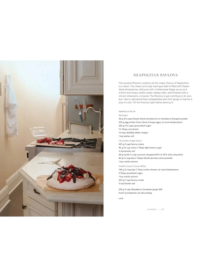Recipe for Neapolitan Pavlova Will This Make You Happy: Stories & Recipes from a Year of Baking by Tanya Bush topped with chocolate and strawberries resting on a kitchen counter | Twentyseven Toronto