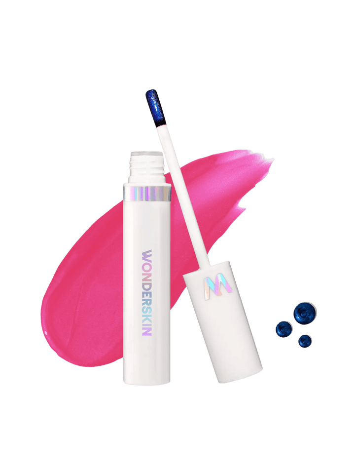 An open tube of Wonderskin WONDER BLADING Lip Stain Masque in Neon Rose with its white wand is shown against a bright pink product swatch | Twentyseven Toronto