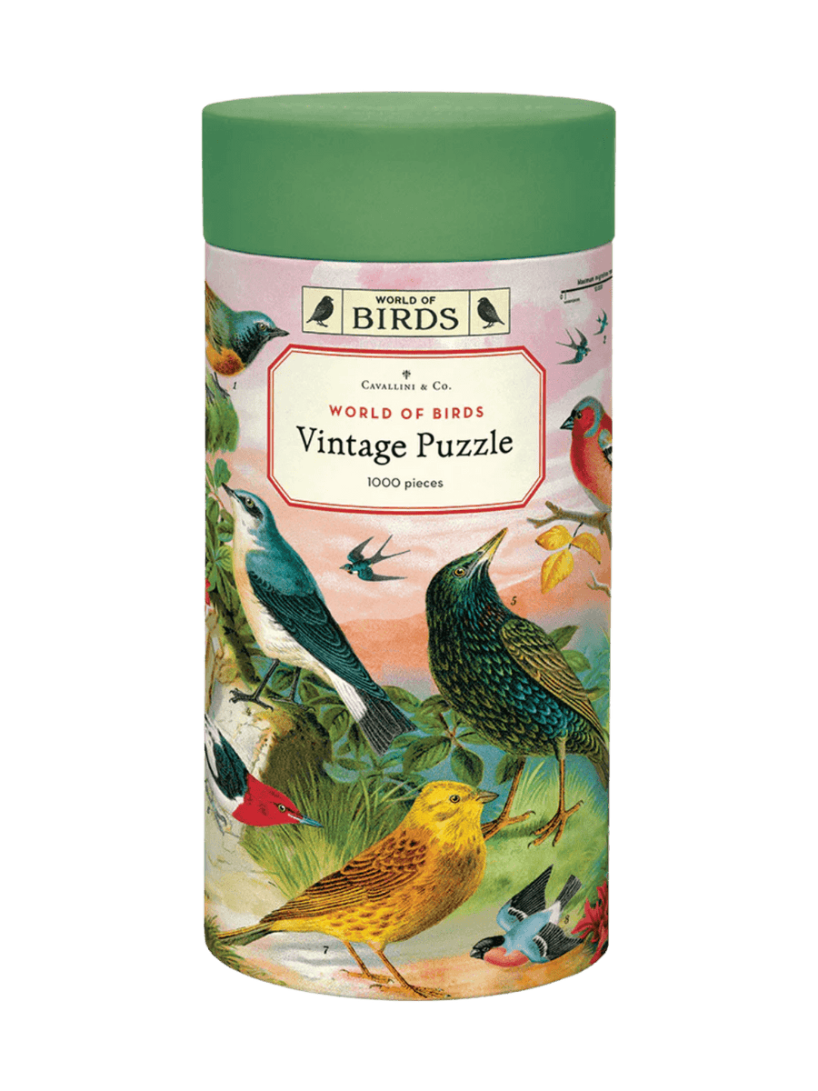 Cylindrical paper tube for the Cavallini Paper & Co World of Birds 1000 Piece Puzzle with a green cap, highlighting a central title card surrounded by vintage drawings of birds | Twentyseven Toronto